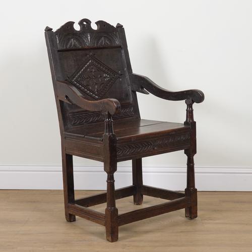 A 17TH CENTURY OAK LANCASHIRE PANELLED BACK WAINSCOT ARMCHAIR