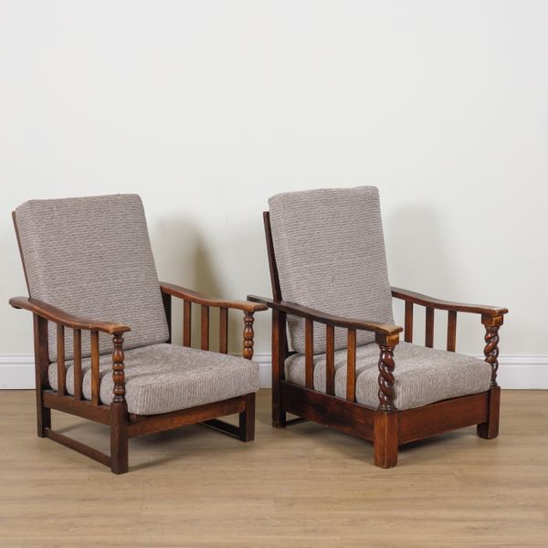 A NEAR PAIR MID 20TH CENTURY OAK FRAMED EASY ARMCHAIRS (2)