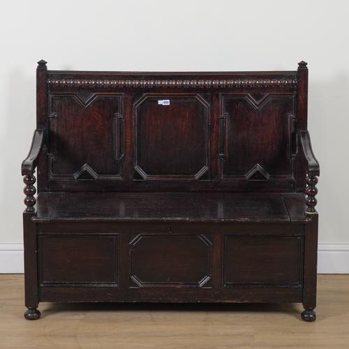 A 17TH CENTURY STYLE OAK BOX SEAT SETTLE