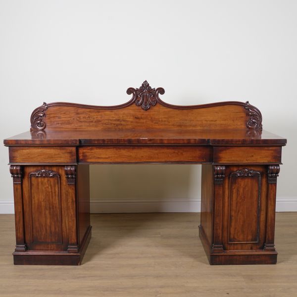 A GEORGE IV MAHOGANY INVERTED BREAKFRONT PEDESTAL SIDEBOARD