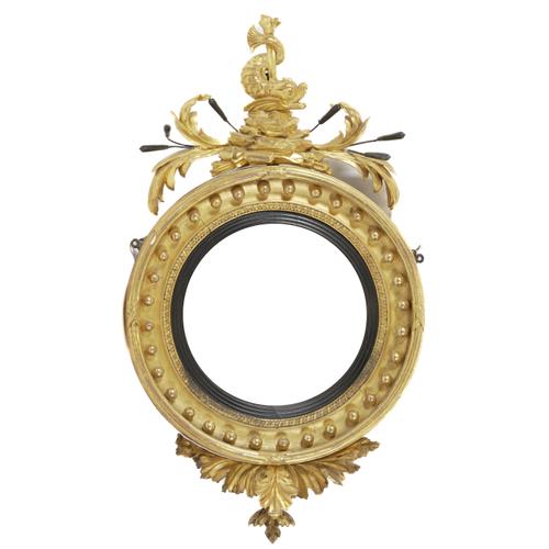 A REGENCY GILT FRAMED CONVEX WALL MIRROR