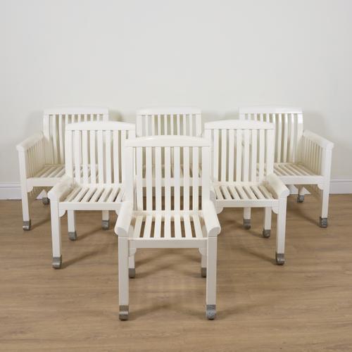 A WHITE PAINTED SLATTED HARDWOOD EIGHT PIECE PATIO SET (8)