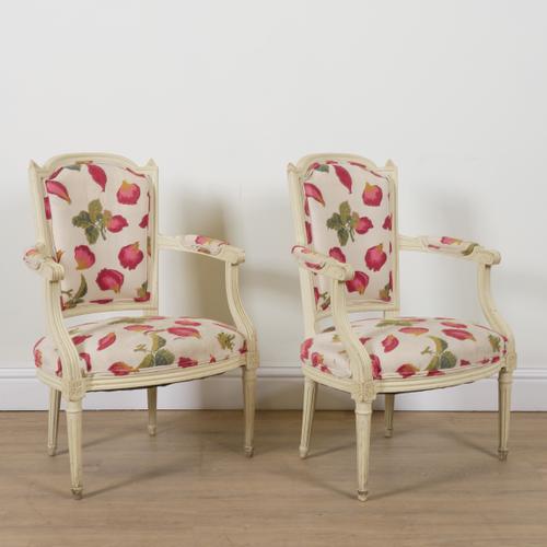 A PAIR OF LOUIS XVI STYLE WHITE PAINTED OPEN ARMCHAIRS (2)