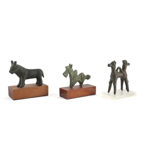 TWO MIDDLE EASTERN BRONZE STATUETTES: A STYLISED QUADRUPED AND A DOUBLE HEADED HORSE (3)