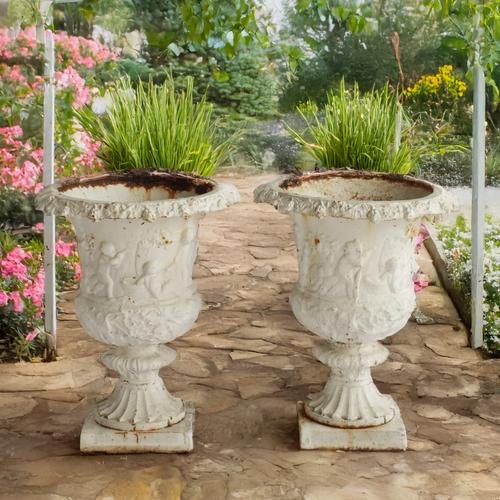 AFTER ANDREW HANDYSIDE; A PAIR OF WHITE PAINTED CAST IRON GARDEN URNS (2)