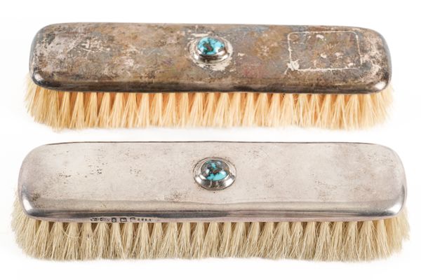 A PAIR OF SILVER MOUNTED AND TURQUOISE MATRIX CLOTHES BRUSHES (2)