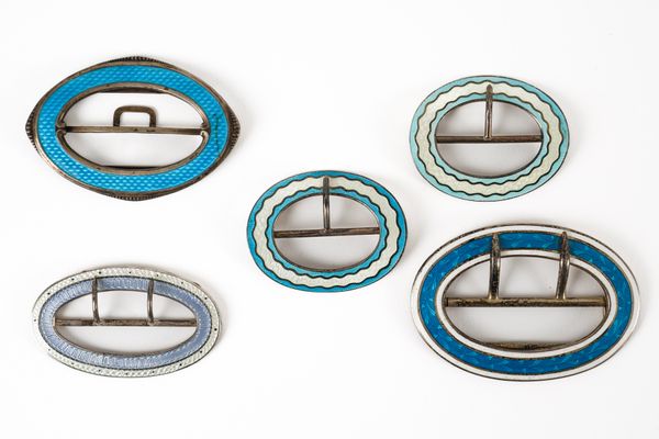 FIVE SILVER AND ENAMELLED OVAL BUCKLES (5)