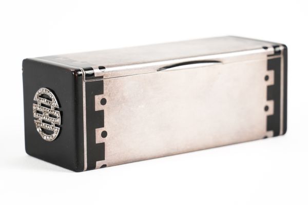 A CARTIER SILVER, DIAMOND SET AND BLACK ENAMELLED RECTANGULAR HINGE LIDDED BOX