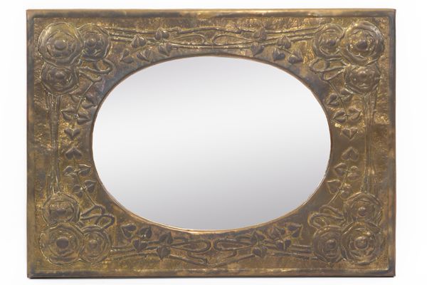 IN THE MANNER OF LIBERTY & CO; AN ARTS & CRAFTS COPPER FRAMED REPOUSSÉ WALL MIRROR