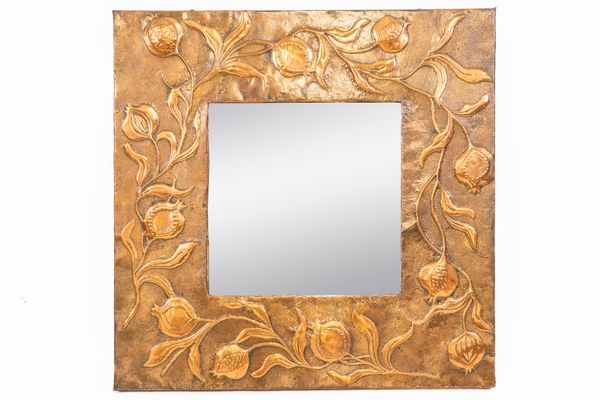 IN THE MANNER OF LIBERTY & CO; AN ARTS & CRAFTS COPPER SQUARE REPOUSSÉ WALL MIRROR