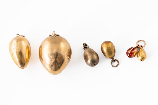 A GROUP OF SIX EGG CHARMS (6)