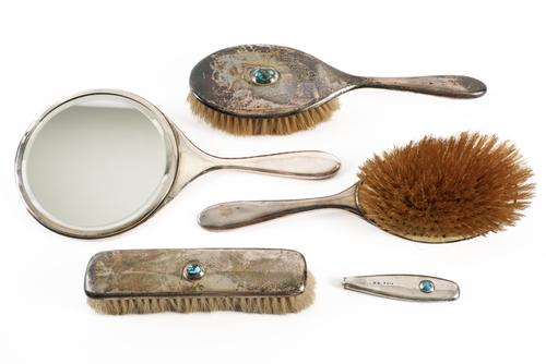 A LIBERTY AND CO SILVER AND TURQUOISE MATRIX MOUNTED GROUP OF DRESSING TABLE WARES (5)