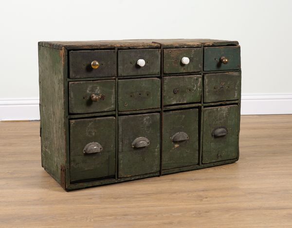 AN EARLY 20TH CENTURY GREEN PAINTED BANK OF TWELVE DRAWERS