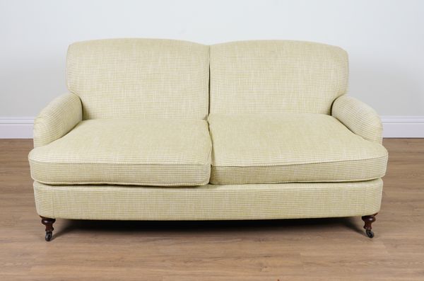 A MODERN GREEN UPHOLSTERED DOUBLE HUMPBACK SOFA