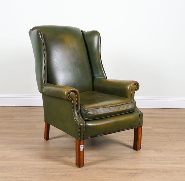 A GEORGE II STYLE STUDDED GREEN LEATHER UPHOLSTERED WINGBACK ARMCHAIR