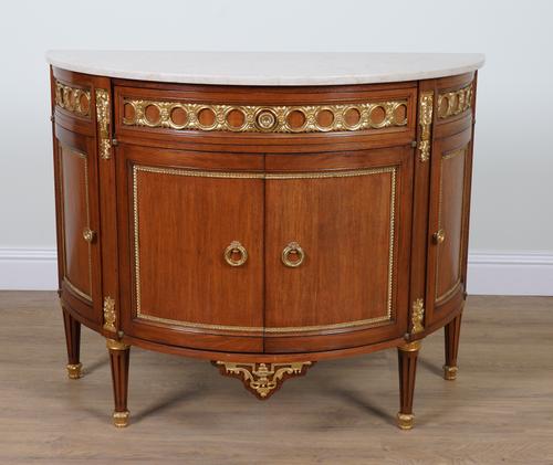 A LOUIS XVI STYLE MARBLE TOPPED DEMI-LUNE COMMODE