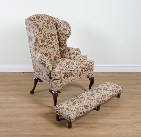 A GEORGE II STYLE WINGBACK ARMCHAIR AND LATER RECTANGULAR FOOTSTOOL (2)