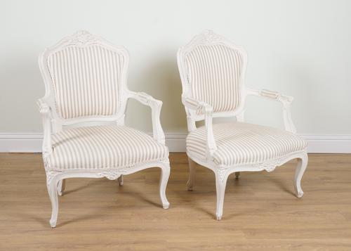 A PAIR OF LOUIS XV STYLE WHITE PAINTED OPEN ARMCHAIRS (2)