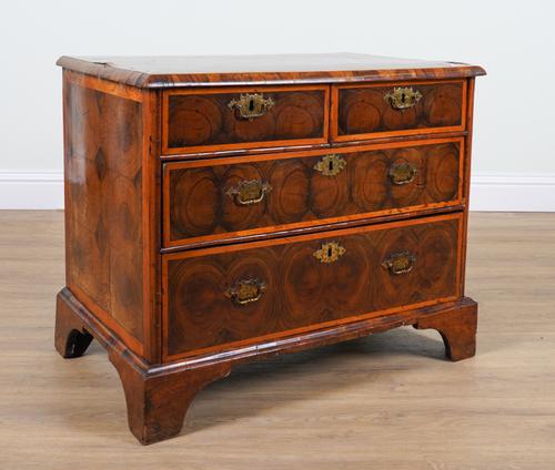 A WILLIAM & MARY GEOMETRIC INLAID OYSTER VENEERED WALNUT FOUR DRAWER CHEST