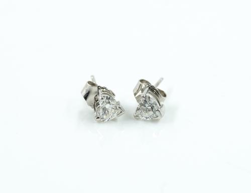A PAIR OF HEART SHAPED DIAMOND SINGLE STONE EARSTUDS