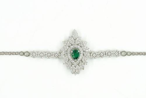 A WHITE GOLD, GREEN AND COLOURLESS GEM SET BRACELET