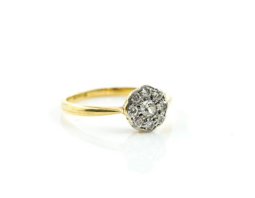 A GOLD AND DIAMOND NINE STONE CLUSTER RING