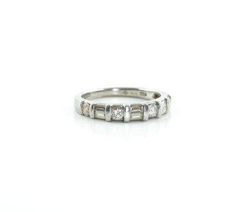 A PLATINUM AND DIAMOND HALF HOOP RING