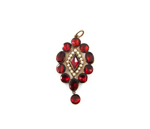 A GOLD AND FOIL BACKED FLAT CUT GARNET AND SEED PEARL PENDANT