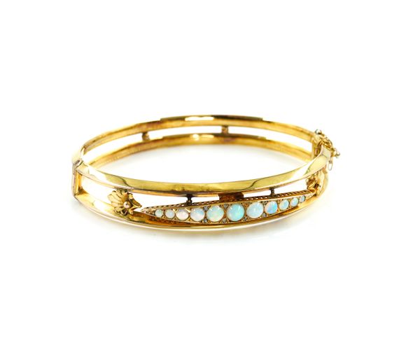 A 9CT GOLD AND OPAL OVAL HINGED BANGLE