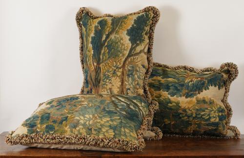 THREE NORTH EUROPEAN VERDURE TAPESTRY FRAGMENT CUSHIONS (3)