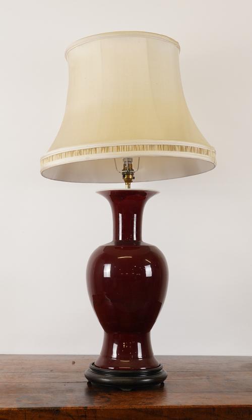 A CHINESE SANG DE BOEUF BALUSTER TABLE LAMP