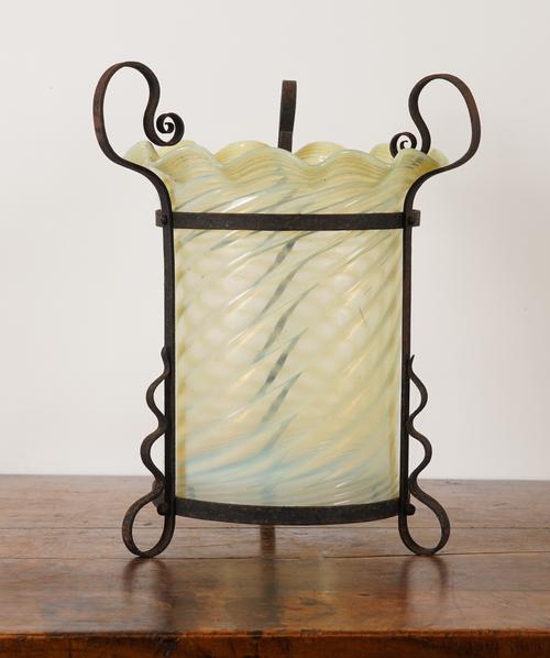 AN ARTS & CRAFTS WROUGHT-IRON LANTERN WITH SHAPED VASELINE GLASS SHADE