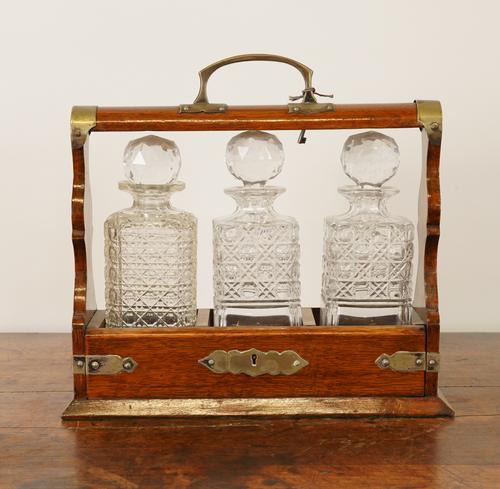 AN EDWARDIAN SILVER-PLATE MOUNTED OAK TANTALUS