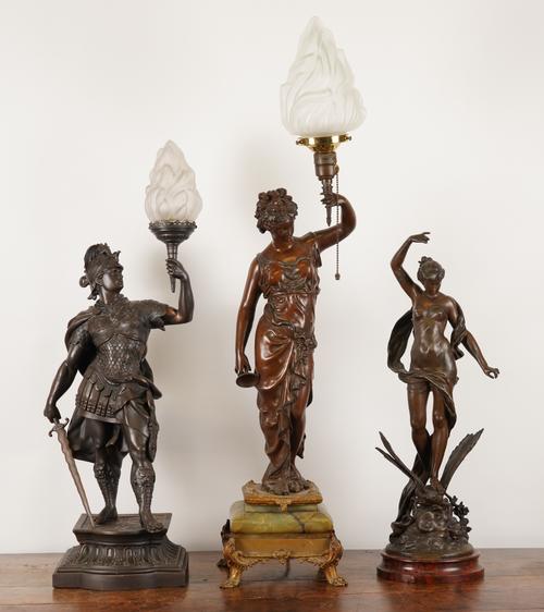 AFTER CHARLES GEORGES FERVILLE-SUAN: A FRENCH SPELTER FIGURE 'LE TRIOMPHE DU PRITEMPS'; TOGETHER WITH TWO SPELTER FIGURAL LAMPS (3)