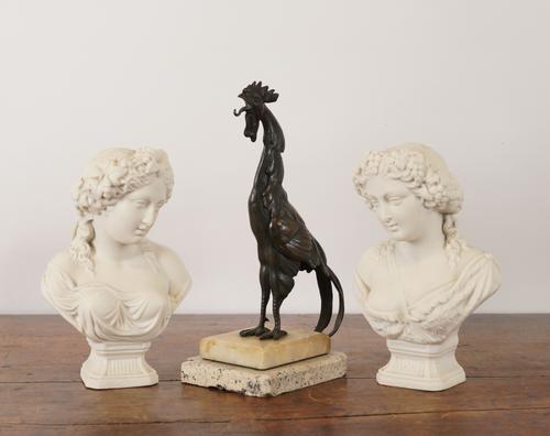 A PAIR OF PARIAN BUSTS TOGETHER WITH A BRONZE COCKEREL (3)