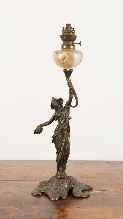 IN THE MANNER OF JAMES HINKS: A BRONZE ART NOUVEAU FIGURAL OIL LAMP