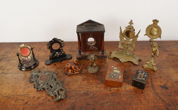 A COLLECTION OF NOVELTY POCKET WATCH STANDS INCLUDING A BRASS CUPID STAND (10)