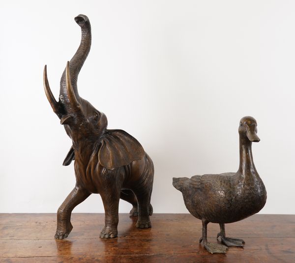 A CAST PATINATED METAL MODEL OF A DUCK AND ANOTHER OF AN ELEPHANT (2)