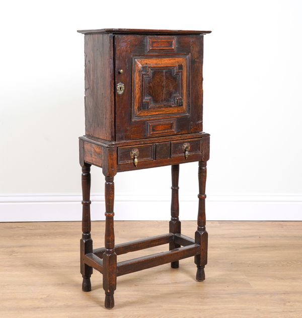 A 17TH CENTURY OAK SPICE CUPBOARD ON STAND