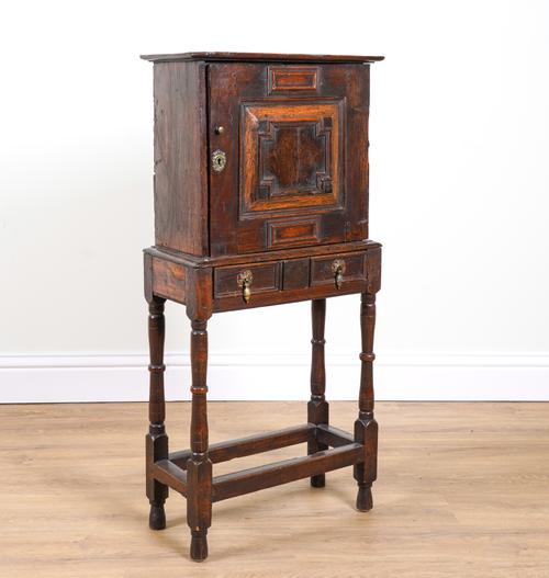 A 17TH CENTURY OAK SPICE CUPBOARD ON STAND