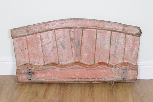 A RED PAINTED PLANKED AND ARCHED HORSE CART BACK