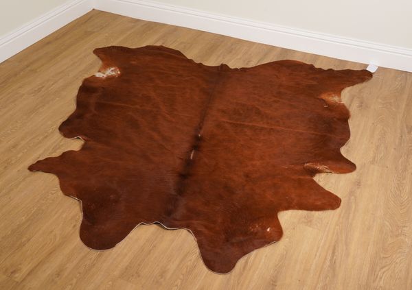 A COW HIDE RUG