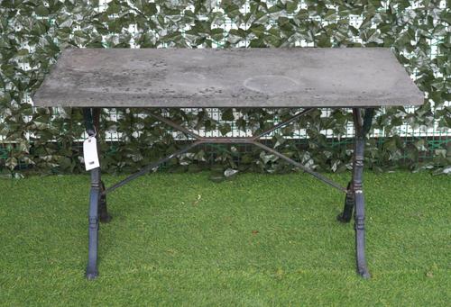A RECTANGULAR SLATE TOPPED GARDEN TABLE