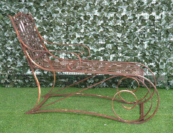 AN EARLY 20TH CENTURY STRAP IRON GARDEN LOUNGER