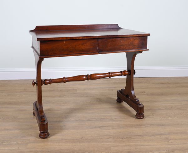 A GEORGE IV MAHOGANY TWO DRAWER WRITING TABLE ON SILHOUETTE TRESTLE SUPPORTS