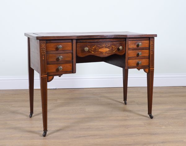 AN EDWARDIAN MARQUETRY INLAID MAHOGANY BOWFRONT SEVEN DRAWER WRITING DESK