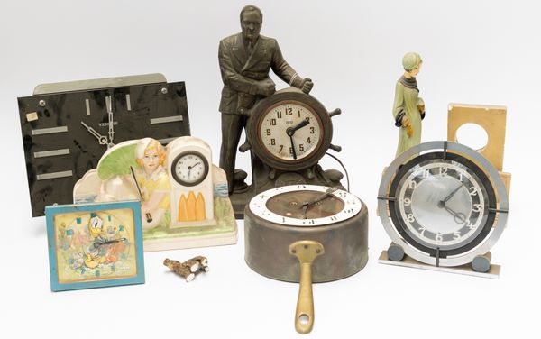 A GROUP OF TIMEPIECES INCLUDING A FIGURAL CLOCK OF A MAN STEERING A SHIP (7)