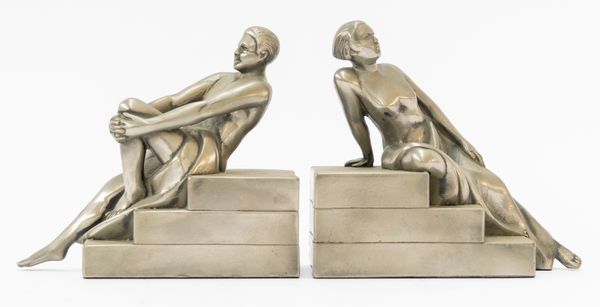 A PAIR OF LEAD ALLOY RECLINING FIGURE BOOKENDS (2)