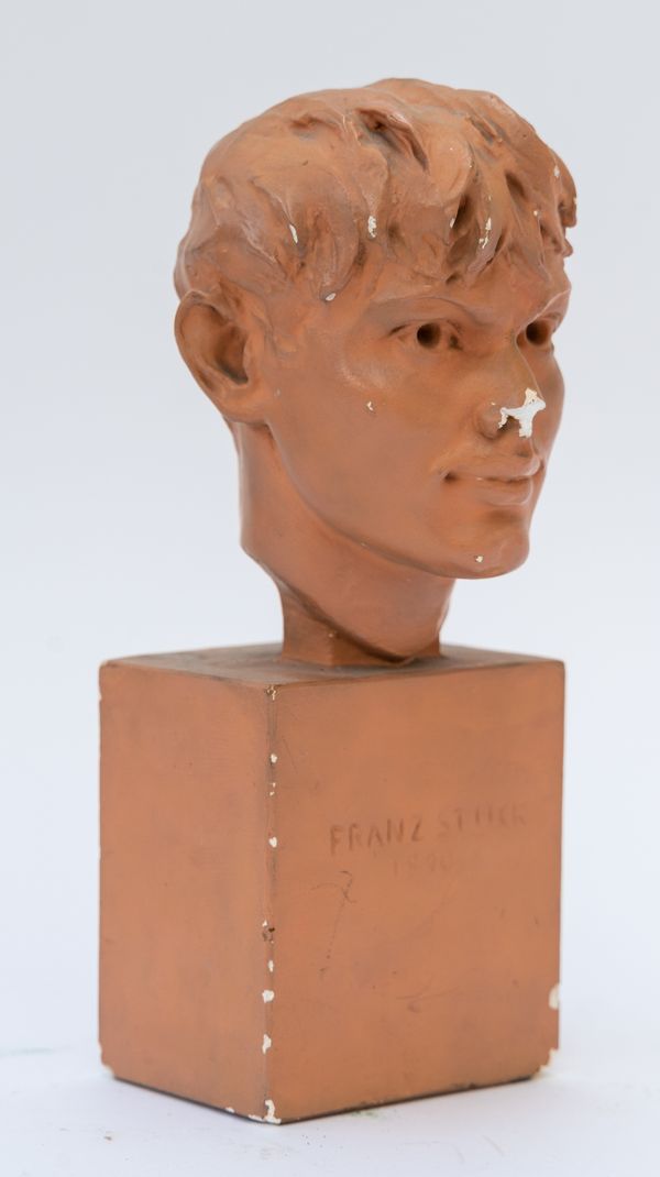 A TERRACOTTA PAINTED PLASTER BUST  OF A YOUNG BOY INSCRIBED ‘FRANZ STUCK 1890’