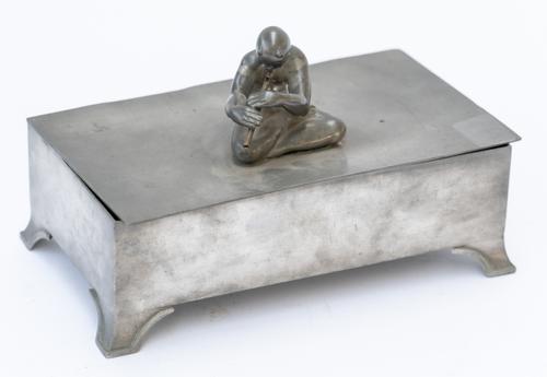 SVENSKT TENN: A SWEDISH PEWTER CIGARETTE OR JEWELLERY BOX MOUNTED WITH A SEATED FIGURE OF PAN